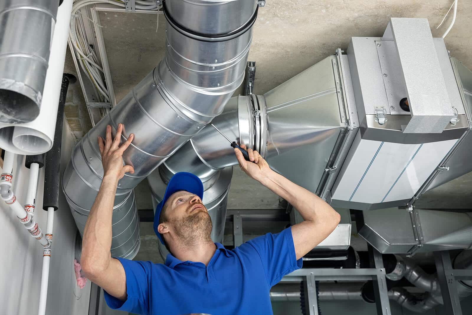 HVAC technician inspecting and repairing air ducts in Bellflower